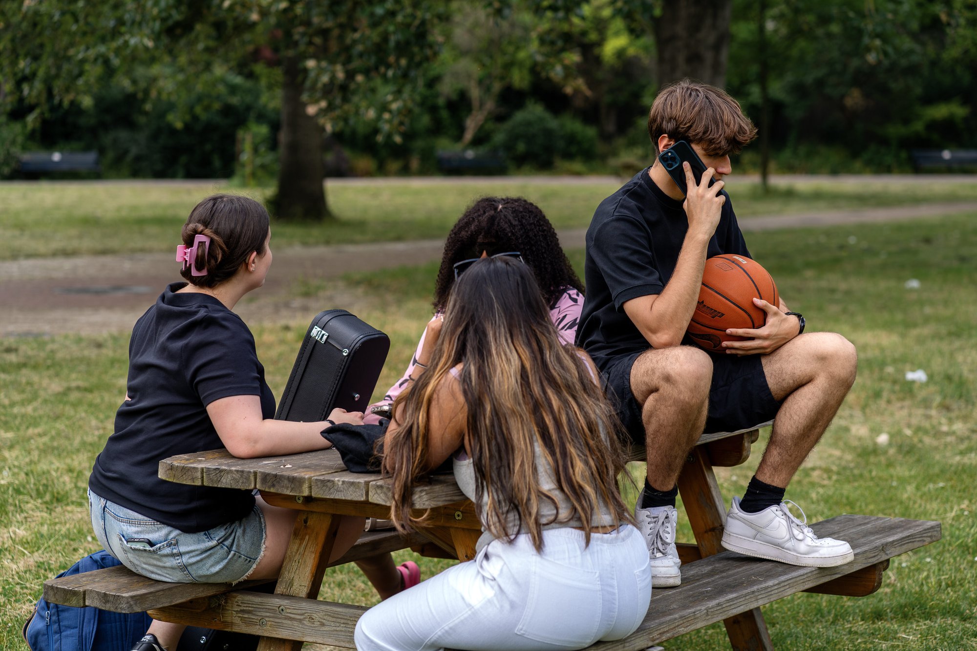 Youn g people sitting on a park bench